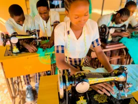 Student sewing in the tailoring workshop